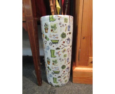 A china cylindrical umbrella and stick stand with all over design of gardening tools and plants, 44cm high 