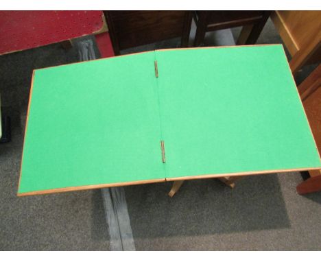 A 1940’s light oak compact card table with baize lining 