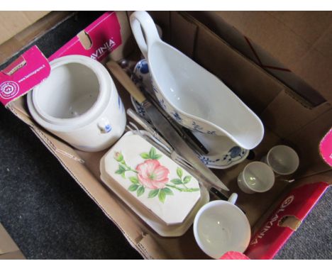Two boxes of assorted china and glassware including cups and saucers, glass vases, and gravy boat 