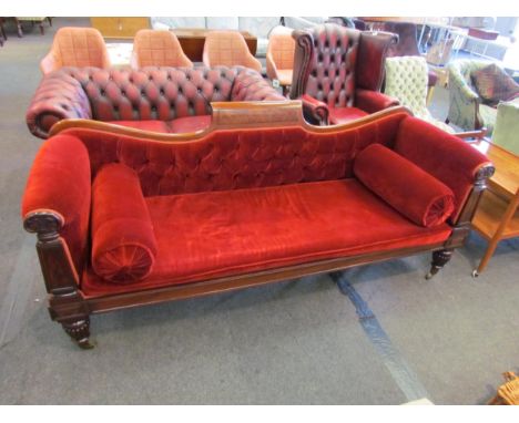 A William IV mahogany sofa, the deep button scroll back rest and scroll arms with carved fascia on turned and melon fluted le