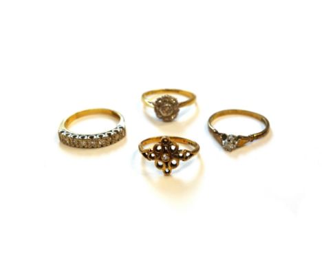 A gold and platinum, diamond set nine stone cluster ring, a gold and diamond set single stone ring, another gold and diamond 