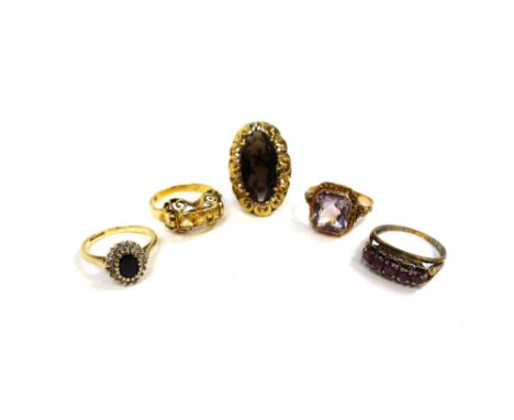 A 9ct gold, sapphire and diamond set oval cluster ring, a gold ring, mounted with an oval cut smoky quartz within a pierced s