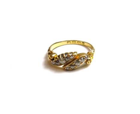 A Victorian 18ct gold and diamond set ring, mounted with two rows of cushion shaped diamonds, in a twin scrolling design, Bir