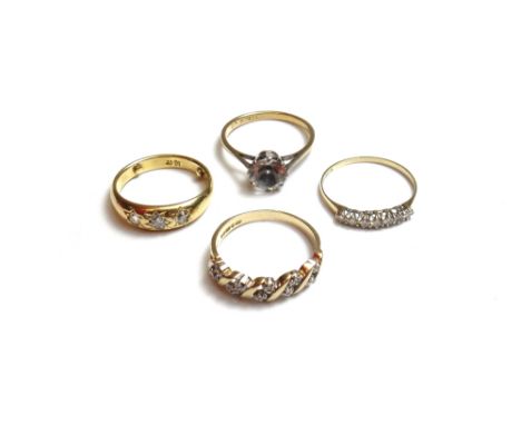 A gold and diamond set three stone ring, gypsy set with cushion shaped diamonds, a 9ct gold and diamond set ring, mounted wit