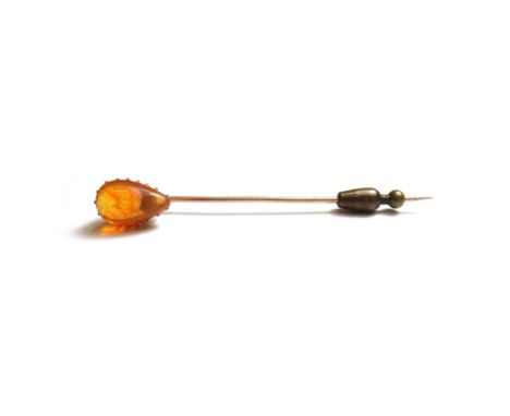 A gold and fire opal set single stone stick pin, mounted with a pear shaped fire opal.