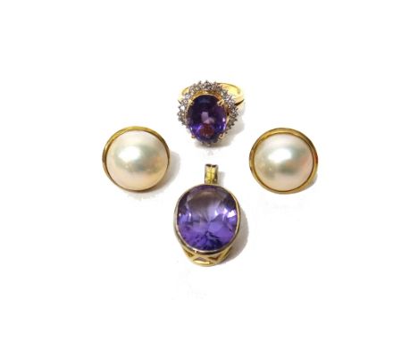 A gold, amethyst and diamond set ring, claw set with the oval cut amethyst at the centre, within an undulating surround mount