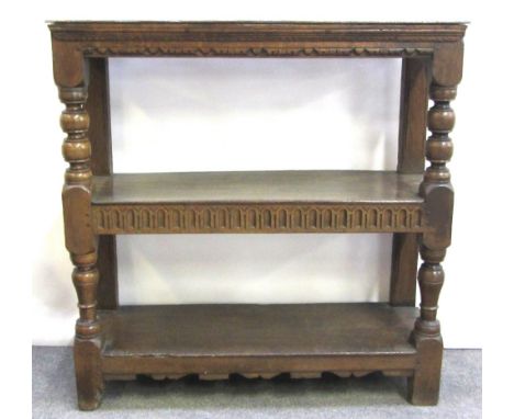 An 18th century and later carved oak three tier buffet on baluster turned supports, 100cm wide.