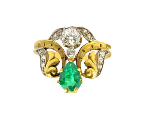 A French gold, diamond and emerald set ring, claw set with the principal cushion shaped diamond below a pear shaped emerald, 