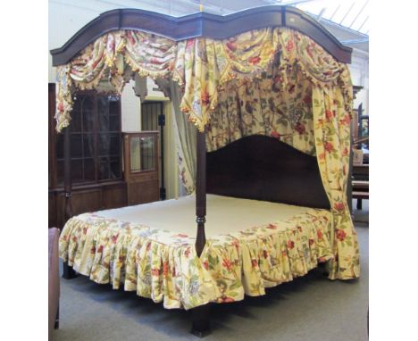 A 20th century hardwood four poster bed, with turned and fluted foot board supports, 183cm wide x 214cm long. 