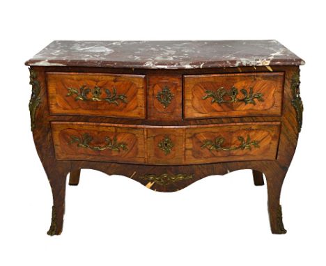 An 18th century style gilt metal mounted rosewood and kingwood commode, the serpentine marble top over a bombe base of two sh