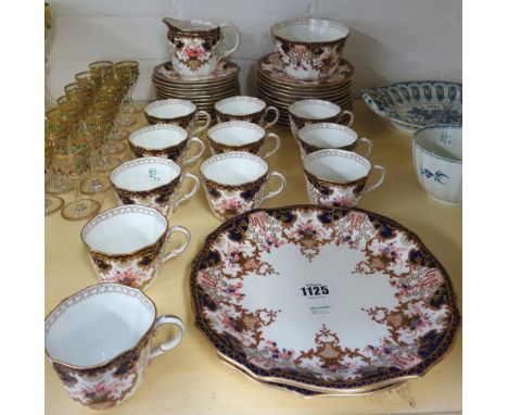 A Royal Crown Derby part tea service, early 20th century, decorated in an Imari pattern and comprising; a milk jug, a sugar b