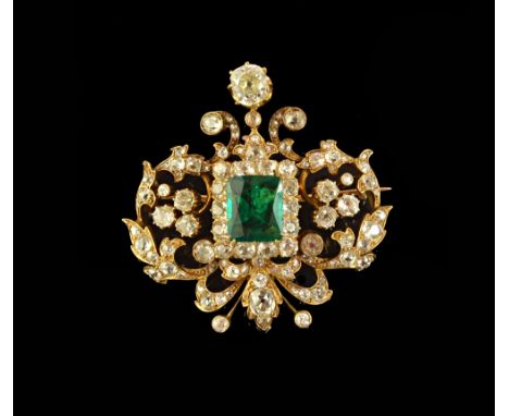 A gold, emerald and diamond set brooch, in a pierced scroll and stylised foliate design, mounted with the rectangular cut eme