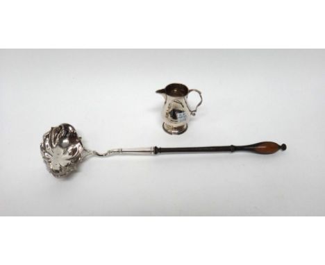 A silver cream jug, of baluster form, with a scrolling handle and on a circular foot, the hallmarks indistinct and a George I
