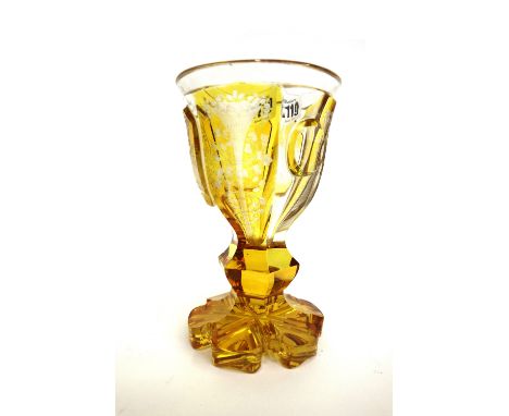 A Bohemian amber etched glass goblet, late 19th century, decorated with a hunting scene over a knopped and faceted stem and s
