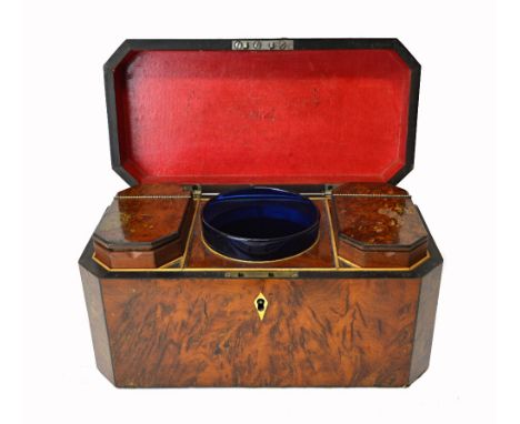 A George III burr yew tea caddy of canted rectangular form, with twin lidded interior centred by a mixing bowl, 29cm wide.  I