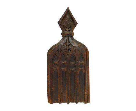 A large carved oak pew end, with diamond surrounded thistle finial over Gothic arch slab side, possibly 16th century, 40cm wi