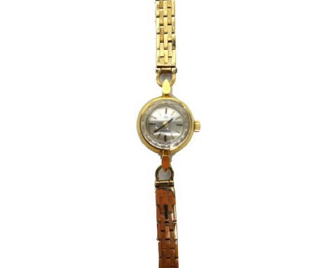 A lady's gold circular cased Omega wristwatch, the signed circular silvered dial with baton shaped numerals, on an associated