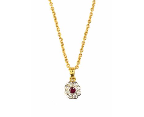An 18ct gold, ruby and diamond set nine stone cluster pendant, mounted with the circular cut ruby at the centre, within a sur