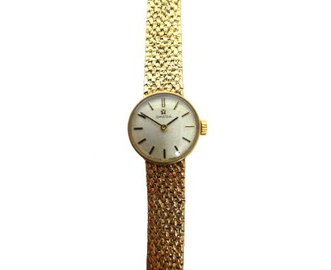 A lady's 9ct gold Omega bracelet wristwatch, the signed circular silvered dial with black baton shaped numerals, on a taperin