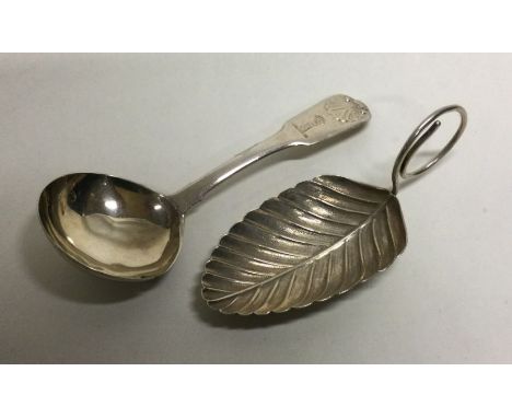 Two silver caddy spoons; one Georgian, the other leaf shaped example apparently unmarked. Approx. grams. Est. £40 - £60.