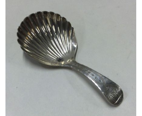 A George III silver caddy spoon with engraved handle. Birmingham 1822. By JT. Approx. 8 grams. Est. £45 - £55.