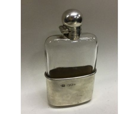 A heavy Victorian silver mounted glass flask with detachable cup and screw-on lid. London 1897. By Sampson Mordan &amp; Co. E