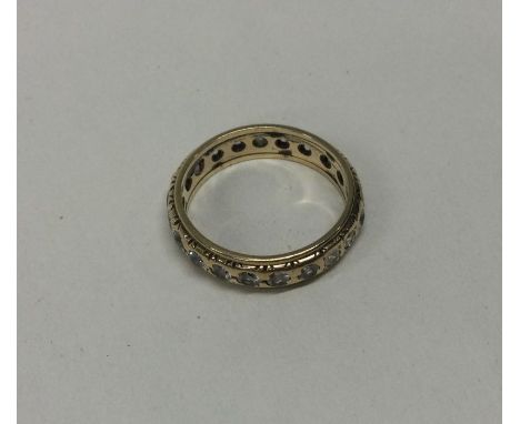 A 9 carat full eternity ring. Approx. 2.7 grams. Est. £50 - £80.
