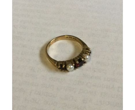 A 9 carat pearl and garnet half hoop ring. Approx. 2.1 grams. Est. £25 - £35.