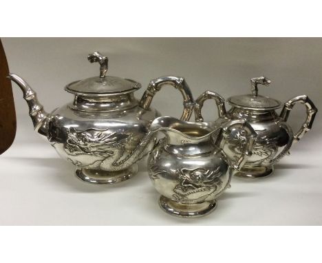 A good Chinese export silver three piece teaset chased with dragons. Marked to base. Circa 1880/90. Approx. 984 grams. Est. £