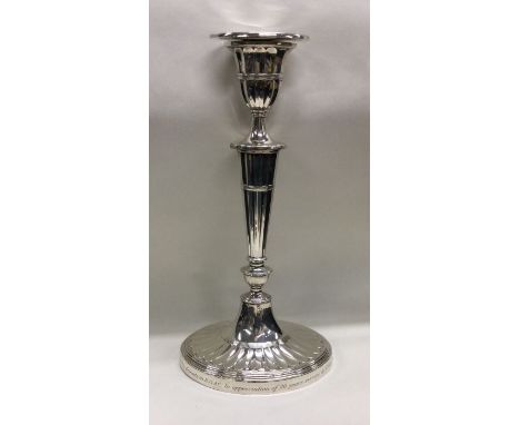 A large Adams' style silver candlestick with fluted decoration. Sheffield. Approx. 629 grams. Est. £100 - £150.