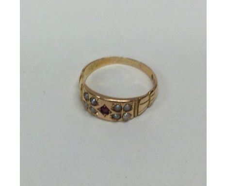 A 15 carat pearl and ruby ring. Approx. 4.4 grams. Est. £60 - £80.