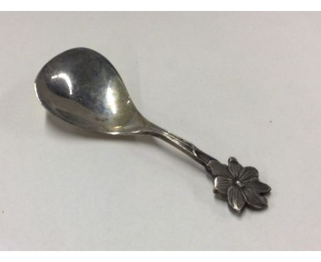 A small silver caddy spoon with floral decoration. Approx. grams. Est. £20 - £30.