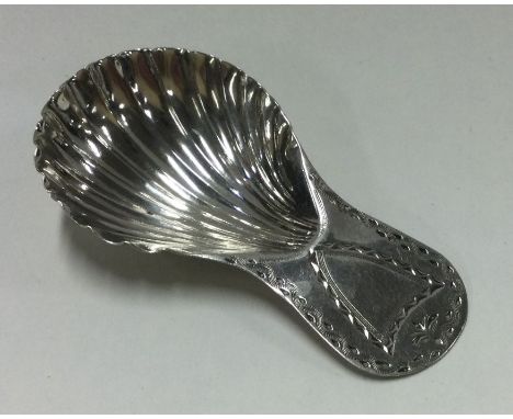 An 18th Century Georgian silver caddy spoon with fluted bowl. Approx. 8 grams. Est. £35 - £45.