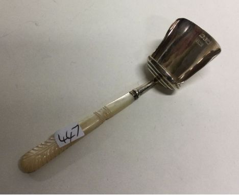 A silver caddy spoon with MOP handle. Birmingham 1893. By H&amp;T. Approx. 13 grams. Est. £30 - £50.