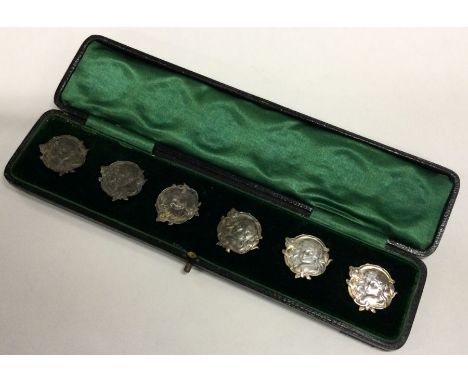 A set of six chased Art Nouveau Sterling silver buttons. Approx. 36 grams. Est. £80 - £120.
