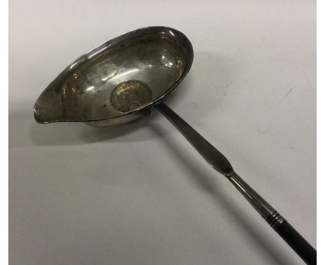 A Georgian silver toddy ladle with whalebone handle. Approx. 47 grams. Est. £20 - £30.