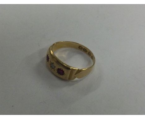 An 18 carat gold ruby and diamond small gypsy set ring. Approx. 2.2 grams. Est. £65 - £70.