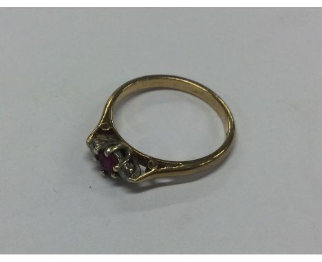 A 9 carat ruby and diamond ring. Approx. 2 grams. Est. £20 - £30.