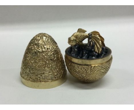 STUART DEVLIN: A cased silver fish 'Surprise' egg. London 1970. Approx. 200 grams. Est. £400 - £600.