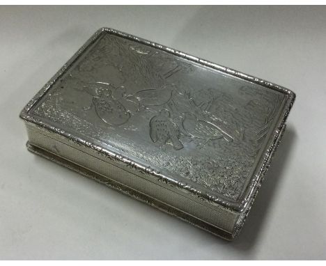 A heavy silver snuff box decorated with birds. Approx. 175 grams. Est. £400 - £500.