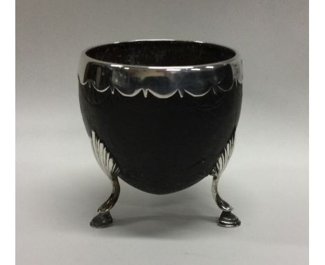 An 18th Century silver mounted coconut cup engraved with ships. Approx. 105 grams. Est. £400 - £500.