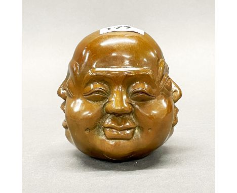 A four faced bronze desk weight, H. 12cm.