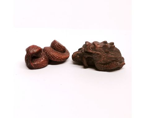 A signed carved fruitwood netsuke of a dragon together with a netsuke of a snake W. 6cm.