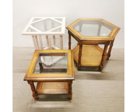 A hexagonal mahogany coffee table with plate glass top and rattan second tier with a matching side table and a further coffee
