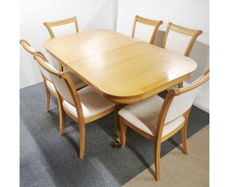 A heavy quality light oak extending dining table with six matching chairs with cream upholstery, unextended L. 175cm W. 100cm