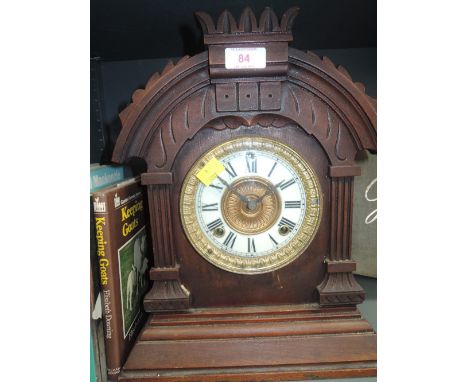 A late Victorian/Edwardian stained frame mantel clock of architectural form having circular Roman numeral dial and striking m