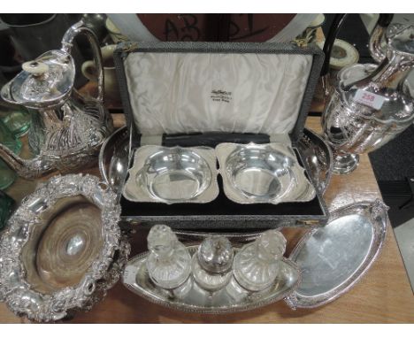 A selection of silver plated items including oval gallery tray, coffee pot, tea pot, pair of wine bottle coasters having grap