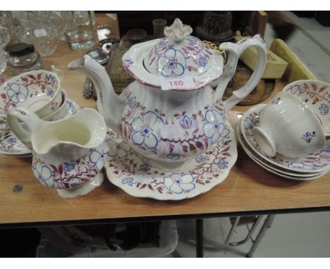 An early 19th century part tea service in the Rockingham style having lustre floral decoration