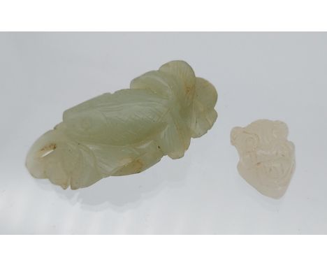Two antique Chinese hand carved jade sculpture of a koi carp and a mask. 