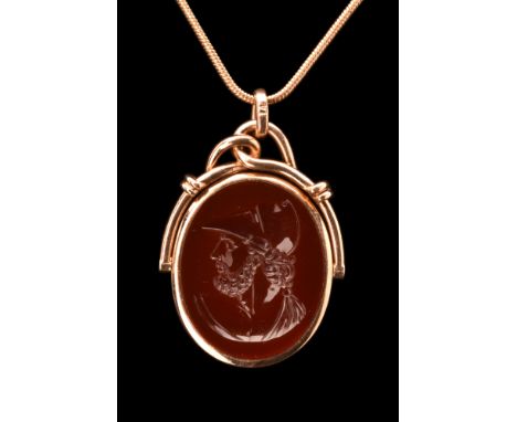 Ca. 1800-1900 AD. An 18K gold pendant of a fine agate, deeply carved with a portrait of a helmeted God Mars facing left.Size: